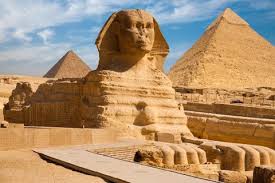 The Great Pyramids of Giza and the surrounding desert viewed during sunset in Egypt.